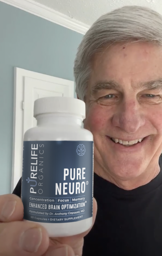 Senior happily holding Pure Neuro from PureLife Organics